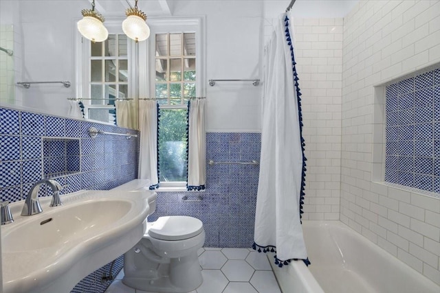 4720 Collinwood Ave, Fort Worth, TX 76107 - bathroom featuring tile walls, a sink, toilet, tile patterned floors, and shower / tub combo with curtain