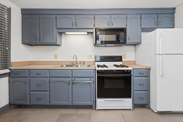 4720 Collinwood Ave, Fort Worth, TX 76107 - kitchen featuring black microwave, range with gas cooktop, a sink, freestanding refrigerator, and light countertops