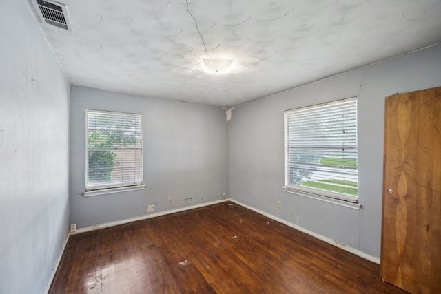 4518 Live Oak Dr, Mesquite, TX 75150 - spare room with wood finished floors, plenty of natural light, and baseboards
