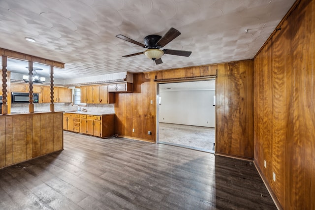 4518 Live Oak Dr, Mesquite, TX 75150 - kitchen with brown cabinetry, black microwave, ceiling fan, light countertops, and dark wood-type flooring