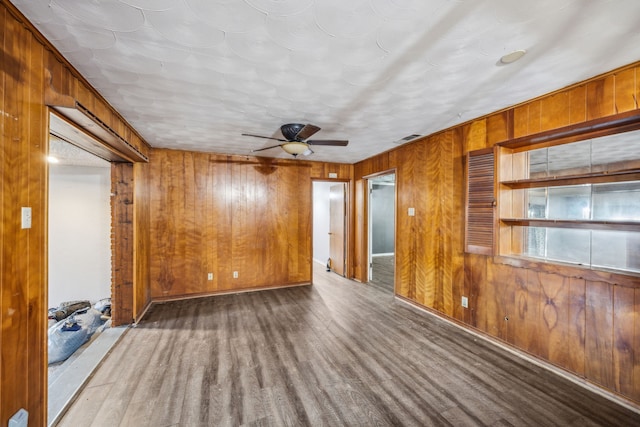4518 Live Oak Dr, Mesquite, TX 75150 - empty room with wood finished floors, wood walls, and ceiling fan