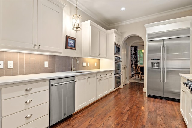 4702 Dexter Ave, Fort Worth, TX 76107 - kitchen featuring built in appliances, a sink, arched walkways, light countertops, and white cabinetry