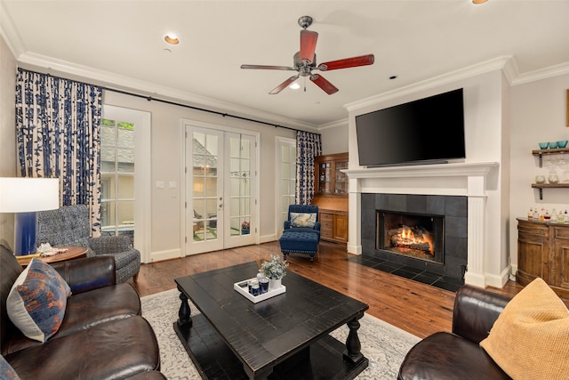 4702 Dexter Ave, Fort Worth, TX 76107 - living room featuring crown molding, wood finished floors, french doors, a fireplace, and ceiling fan