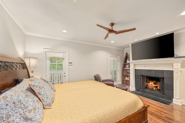 4702 Dexter Ave, Fort Worth, TX 76107 - bedroom featuring access to exterior, ornamental molding, wood finished floors, a tiled fireplace, and ceiling fan