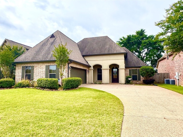 french provincial home featuring an attached garage, concrete driveway, brick siding, and roof with shingles