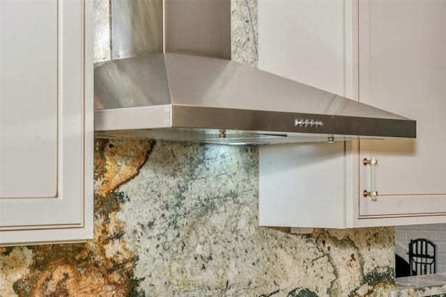 7616 Circle Dr, North Richland Hills, TX 76180 - kitchen view of wall chimney exhaust hood, backsplash, and white cabinetry