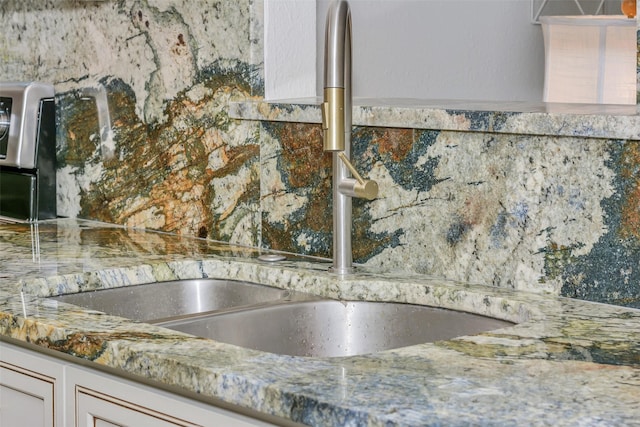 7616 Circle Dr, North Richland Hills, TX 76180 - kitchen view of a sink, decorative backsplash, and stone countertops