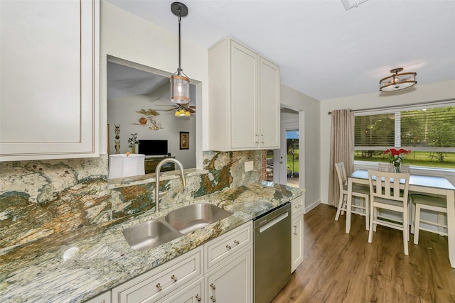 7616 Circle Dr, North Richland Hills, TX 76180 - kitchen with stainless steel dishwasher, a sink, decorative backsplash, light wood-type flooring, and white cabinetry