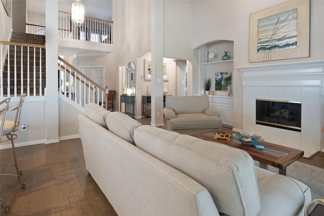4620 Friars Ln, Grand Prairie, TX 75052 - living area featuring built in features, stairway, baseboards, dark wood-type flooring, and a tile fireplace
