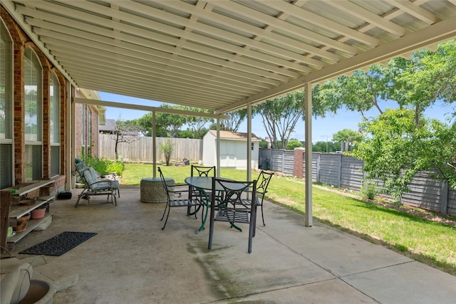 4620 Friars Ln, Grand Prairie, TX 75052 - view of patio with a storage shed, outdoor dining space, and an outbuilding