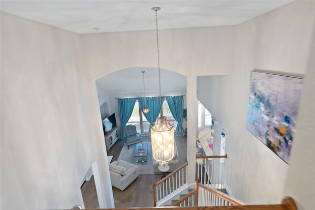 4620 Friars Ln, Grand Prairie, TX 75052 - staircase with a chandelier, wood finished floors, and arched walkways