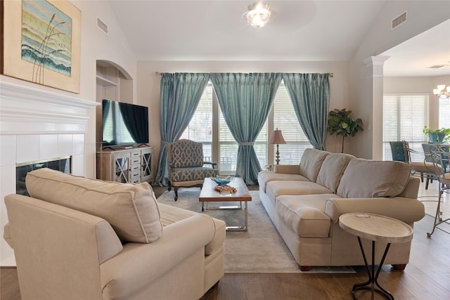 4620 Friars Ln, Grand Prairie, TX 75052 - living area with vaulted ceiling, a tiled fireplace, healthy amount of natural light, a chandelier, and wood finished floors