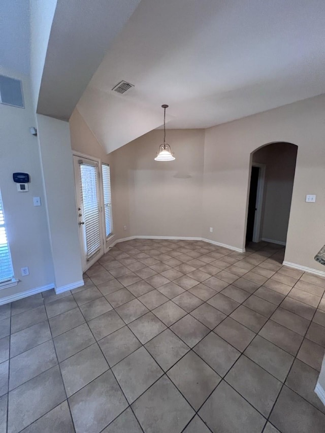 8205 Fountain Springs Dr, Plano, TX 75025 - unfurnished room with arched walkways, light tile patterned floors, lofted ceiling, and baseboards