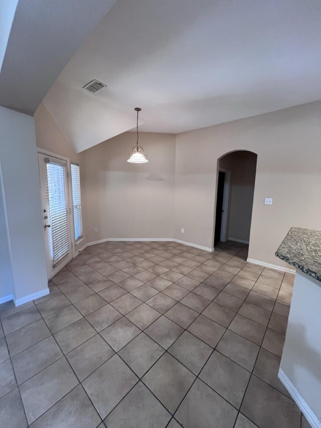 8205 Fountain Springs Dr, Plano, TX 75025 - unfurnished room featuring arched walkways, lofted ceiling, light tile patterned floors, and baseboards