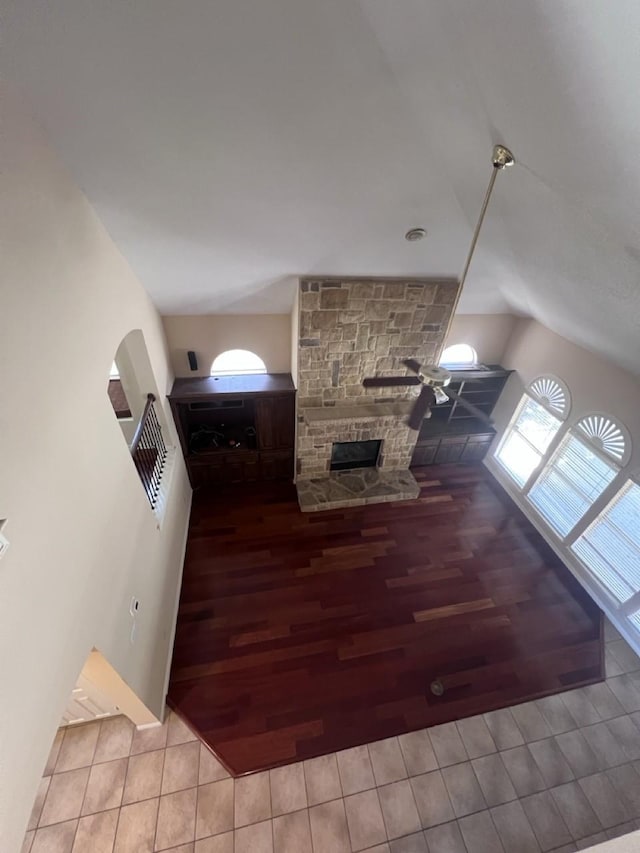 8205 Fountain Springs Dr, Plano, TX 75025 - tiled living room featuring vaulted ceiling and a fireplace
