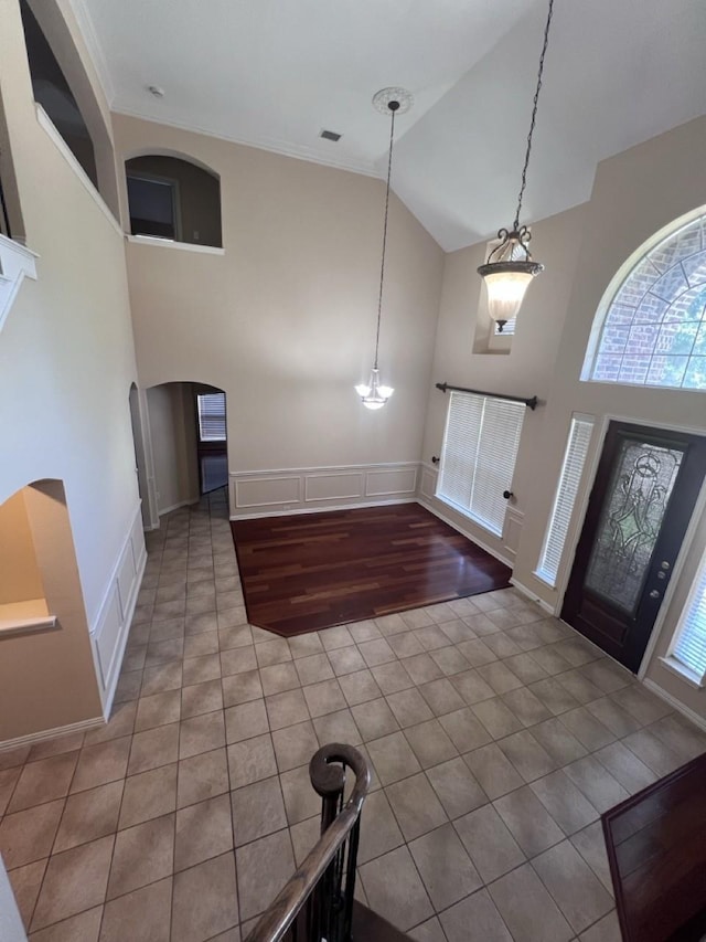 8205 Fountain Springs Dr, Plano, TX 75025 - tiled entryway featuring high vaulted ceiling, arched walkways, and baseboards