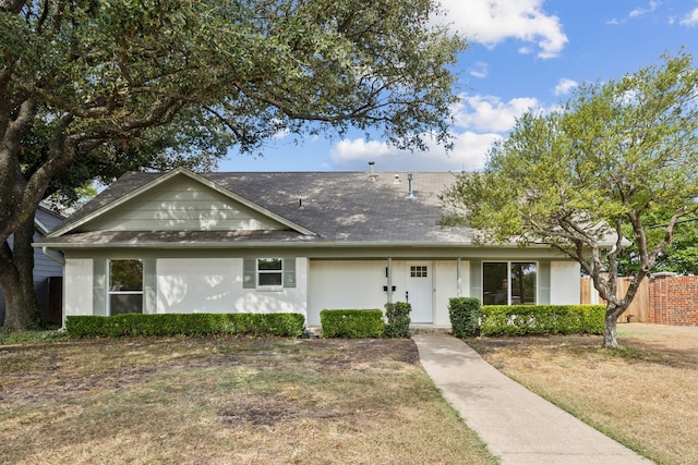 ranch-style house featuring roof with shingles