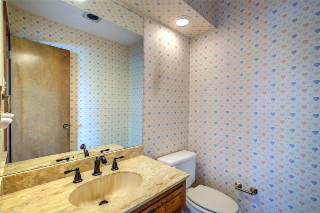 3438 Morning Star Ln, Garland, TX 75043 - bathroom featuring wallpapered walls, toilet, and vanity