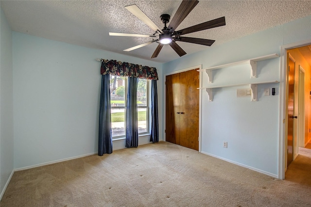 3438 Morning Star Ln, Garland, TX 75043 - unfurnished bedroom featuring a textured ceiling, light colored carpet, a closet, ceiling fan, and baseboards