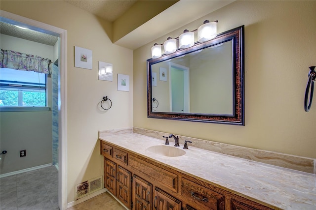3438 Morning Star Ln, Garland, TX 75043 - bathroom with vanity, baseboards, and tile patterned flooring
