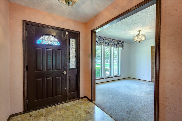 3438 Morning Star Ln, Garland, TX 75043 - entrance foyer with a textured ceiling, a chandelier, baseboards, and light colored carpet