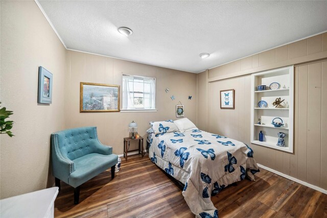 7223 Fm 2494, Athens, TX 75751 - bedroom with wood finished floors, baseboards, a textured ceiling, crown molding, and wooden walls
