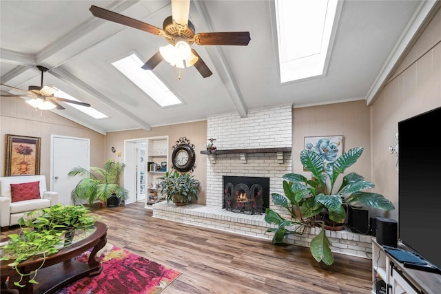 7223 Fm 2494, Athens, TX 75751 - living room with a skylight, ceiling fan, wood finished floors, and a brick fireplace