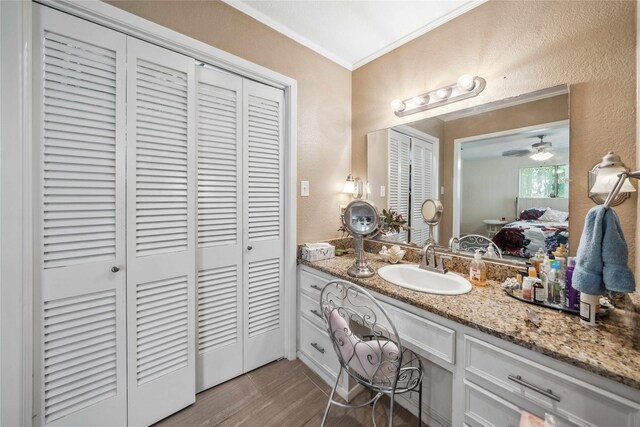 7223 Fm 2494, Athens, TX 75751 - bathroom featuring a textured wall, a closet, crown molding, vanity, and wood finished floors