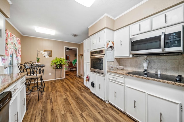 7223 Fm 2494, Athens, TX 75751 - kitchen with appliances with stainless steel finishes, crown molding, wood finished floors, tasteful backsplash, and white cabinets