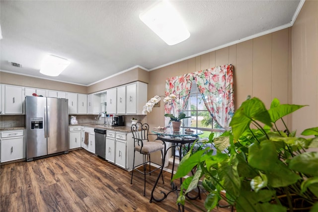 7223 Fm 2494, Athens, TX 75751 - kitchen with stainless steel appliances, a sink, white cabinetry, crown molding, and a textured ceiling