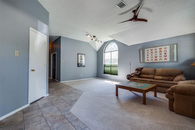 living area with ceiling fan, lofted ceiling, a textured ceiling, carpet floors, and baseboards