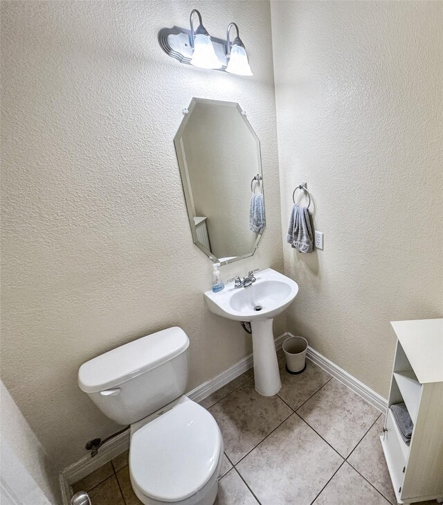 4317 Bay Meadow Dr, Denton, TX 76210 - half bathroom featuring toilet, tile patterned flooring, baseboards, and a textured wall
