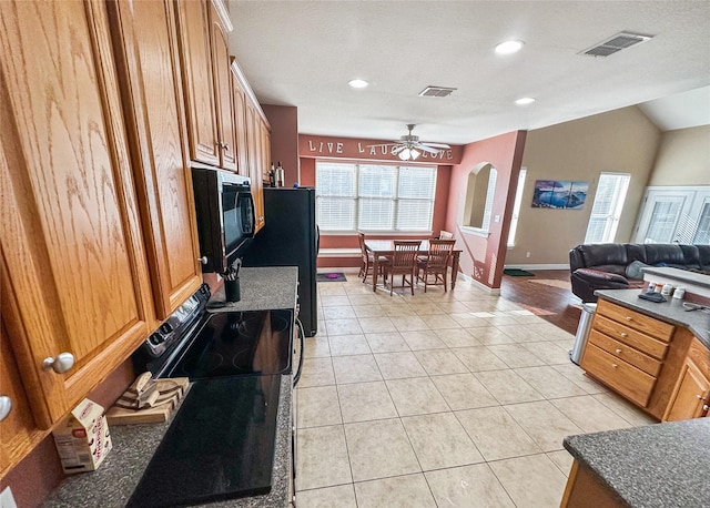 4317 Bay Meadow Dr, Denton, TX 76210 - kitchen featuring a ceiling fan, black appliances, light tile patterned floors, brown cabinets, and open floor plan