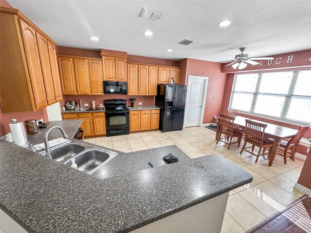 4317 Bay Meadow Dr, Denton, TX 76210 - kitchen featuring black appliances, a sink, ceiling fan, dark countertops, and a peninsula