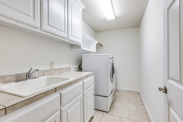 3209 S Bay Breeze Ln, Fort Worth, TX 76179 - laundry area featuring cabinet space, light tile patterned floors, baseboards, and washing machine and dryer