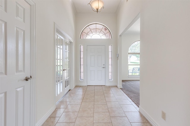 3209 S Bay Breeze Ln, Fort Worth, TX 76179 - entrance foyer with crown molding, light tile patterned flooring, baseboards, and light colored carpet