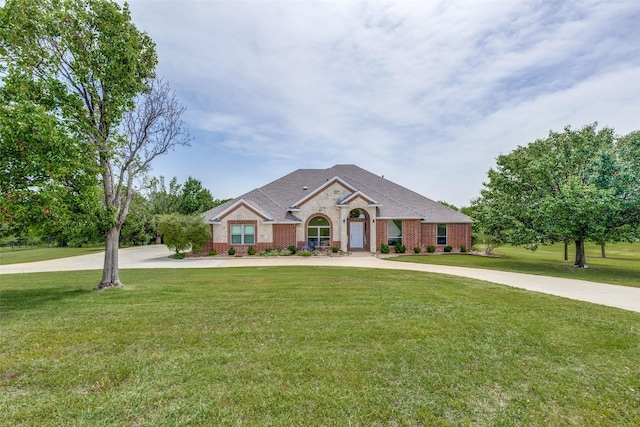 3209 S Bay Breeze Ln, Fort Worth, TX 76179 - view of front of home featuring a front yard, concrete driveway, and brick siding