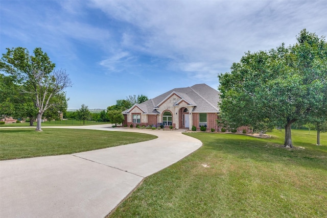 3209 S Bay Breeze Ln, Fort Worth, TX 76179 - view of front facade with curved driveway, brick siding, and a front lawn