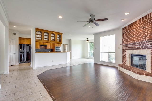 3209 S Bay Breeze Ln, Fort Worth, TX 76179 - unfurnished living room featuring a ceiling fan, recessed lighting, crown molding, a brick fireplace, and light tile patterned floors