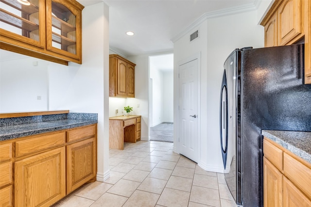 3209 S Bay Breeze Ln, Fort Worth, TX 76179 - kitchen featuring freestanding refrigerator, glass insert cabinets, light tile patterned floors, baseboards, and crown molding