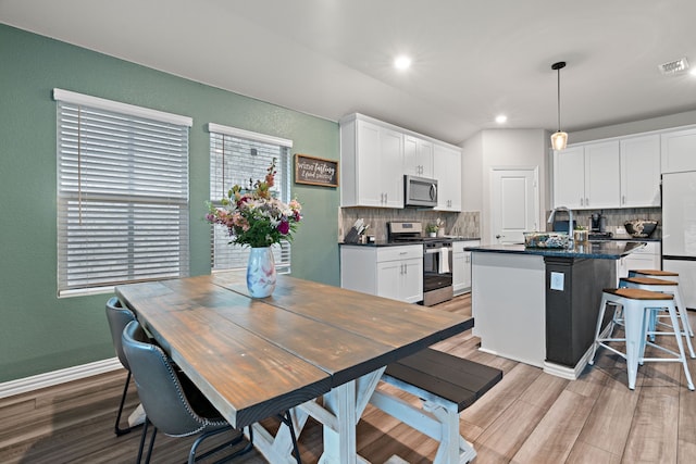 3112 Kingsgarden Rd, Denton, TX 76207 - kitchen featuring appliances with stainless steel finishes, dark countertops, backsplash, white cabinetry, and recessed lighting