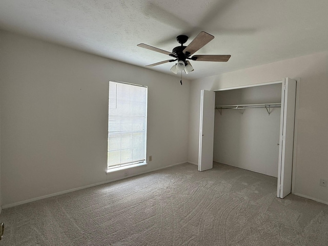 unfurnished bedroom with light colored carpet, multiple windows, and a closet