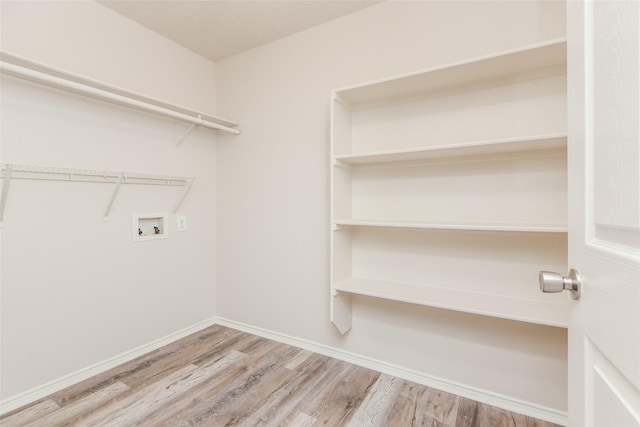 4913 Creek Ridge Trl, Fort Worth, TX 76179 - clothes washing area with washer hookup, wood finished floors, and baseboards