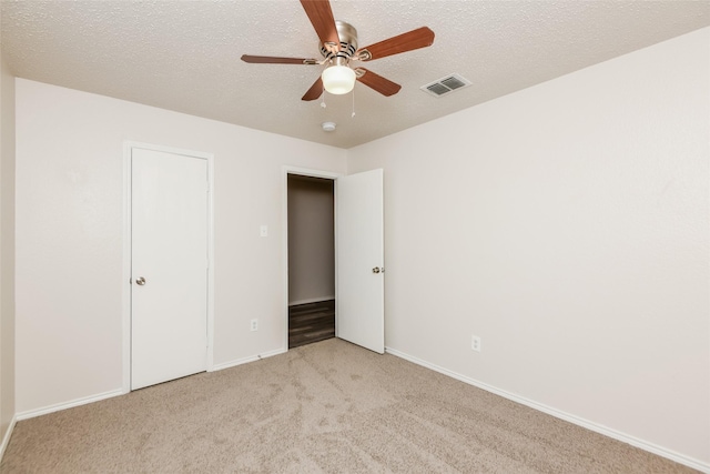 4913 Creek Ridge Trl, Fort Worth, TX 76179 - unfurnished bedroom featuring light carpet, baseboards, a textured ceiling, and ceiling fan