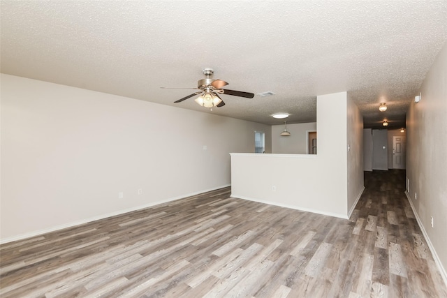 4913 Creek Ridge Trl, Fort Worth, TX 76179 - unfurnished living room with wood finished floors, ceiling fan, a textured ceiling, and baseboards