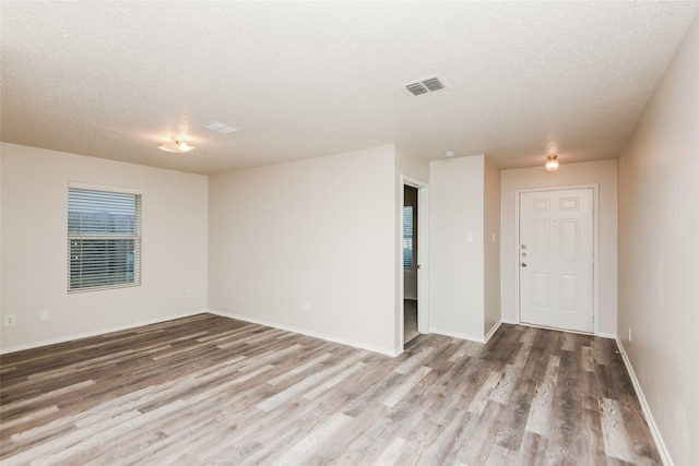 4913 Creek Ridge Trl, Fort Worth, TX 76179 - unfurnished room with wood finished floors, a textured ceiling, and baseboards
