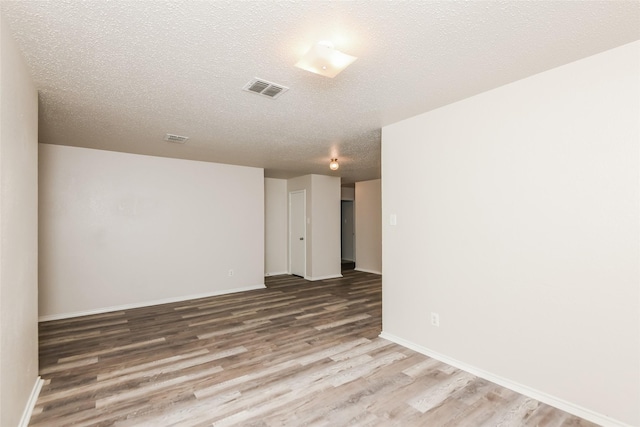 4913 Creek Ridge Trl, Fort Worth, TX 76179 - unfurnished room featuring wood finished floors, a textured ceiling, and baseboards
