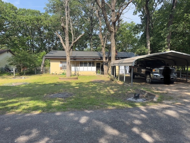 1505 Grove Dr, West Tawakoni, TX 75474 - ranch-style home with a front lawn and a carport