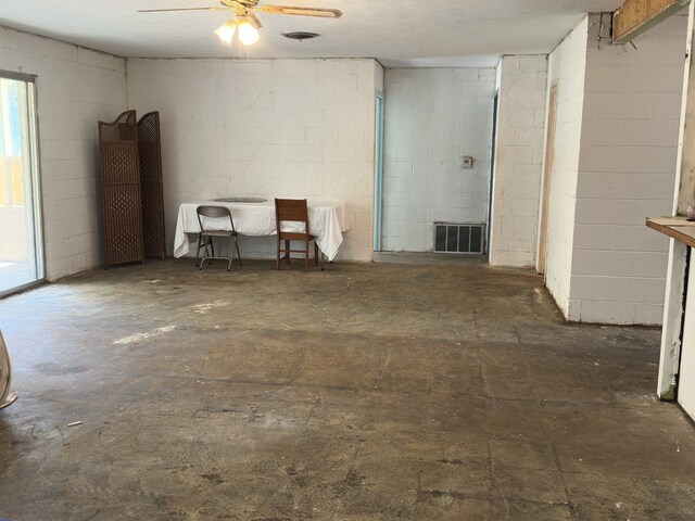 1505 Grove Dr, West Tawakoni, TX 75474 - unfurnished room featuring concrete block wall, a ceiling fan, and unfinished concrete flooring