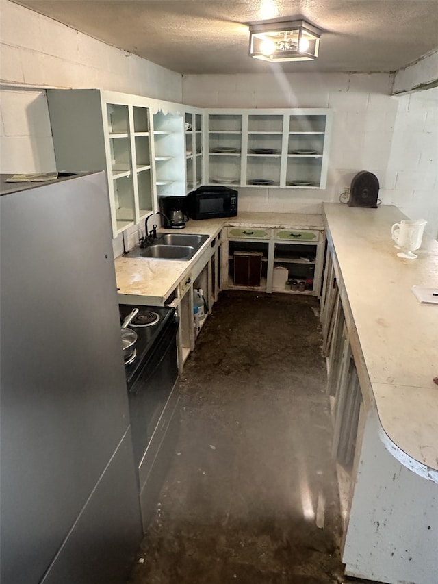 1505 Grove Dr, West Tawakoni, TX 75474 - kitchen with black appliances, a sink, unfinished concrete flooring, concrete block wall, and open shelves